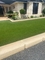 Il pavimento falso verde all'aperto dell'erba tappezza il tappeto erboso artificiale sintetico per il giardino fornitore